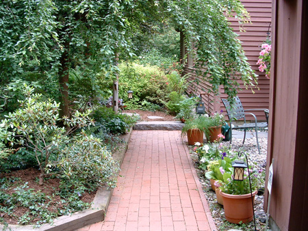 This brick walkway was originally installed 20 years before Jim McSweeney and the Hilltown Tree & Garden crew brought a new patio and landscape design to the home. It was damaged by frost heave and was reset as picture here.